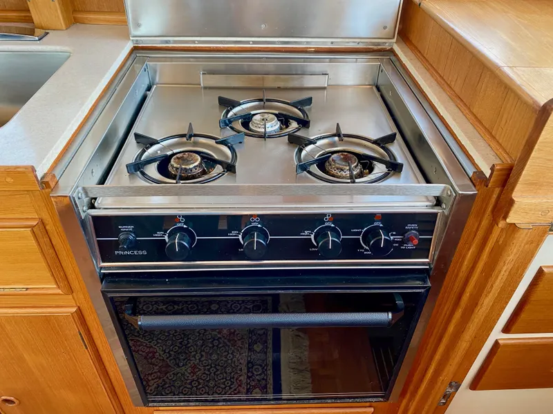 Slide: The Image of Three-burner stove and oven in 1997 Grand Banks Classic yacht kitchen. - 24