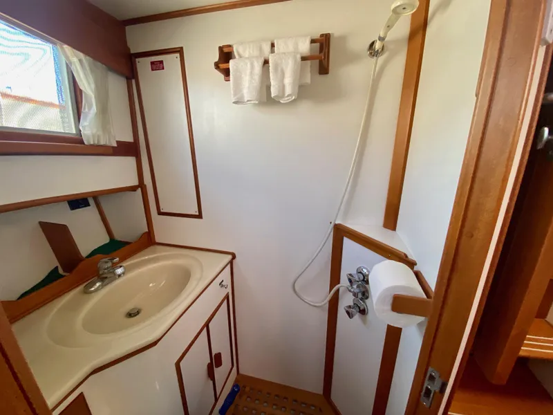 Slide: The Image of Bathroom interior of 1997 Grand Banks Classic yacht, featuring sink and shower. - 39
