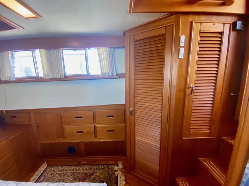 Slide: The Image of 1997 Grand Banks Classic interior with wooden cabinetry and windows, showcasing elegant nautical design. - 31