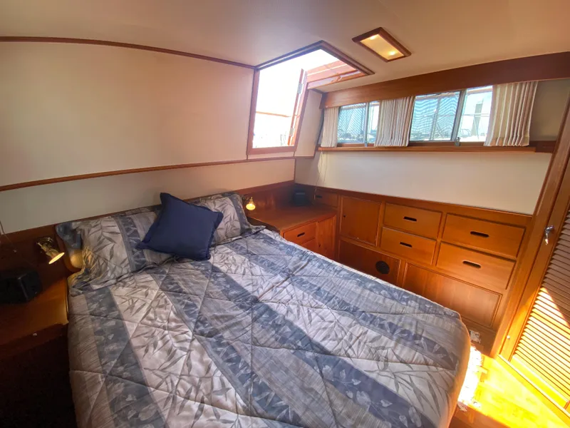 Slide: The Image of Cozy bedroom in 1997 Grand Banks Classic yacht with wood cabinetry and natural light. - 27