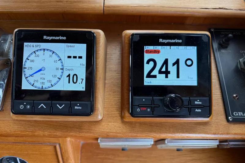 Slide: The Image of Raymarine navigation displays on 1997 Grand Banks Classic boat dashboard, showing speed and heading. - 17