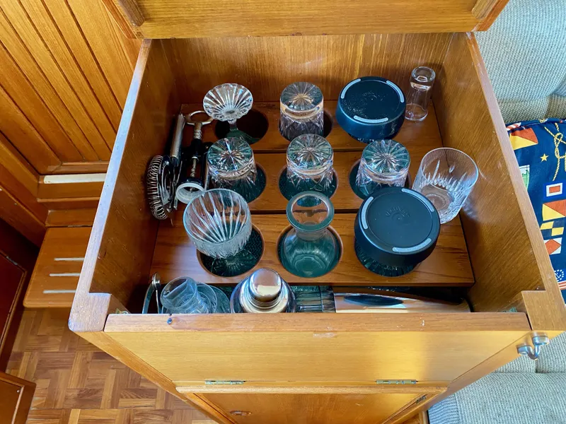 Slide: The Image of Barware collection in a wooden cabinet on a 1997 Grand Banks Classic boat. - 21