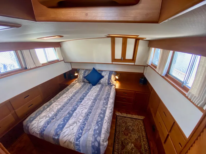 Slide: The Image of Cozy bedroom in 1997 Grand Banks Classic yacht with wood accents and natural light. - 26