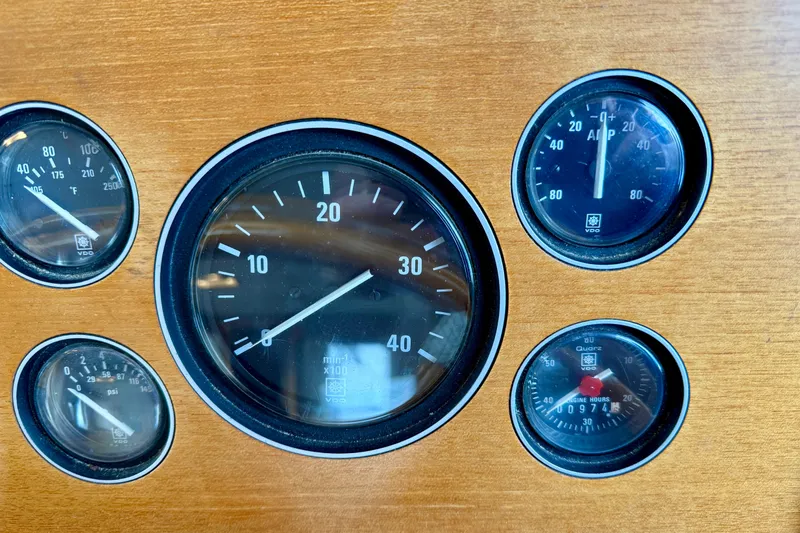 Slide: The Image of Dashboard gauges of a 1997 Grand Banks Classic boat, featuring speedometer and engine indicators. - 47