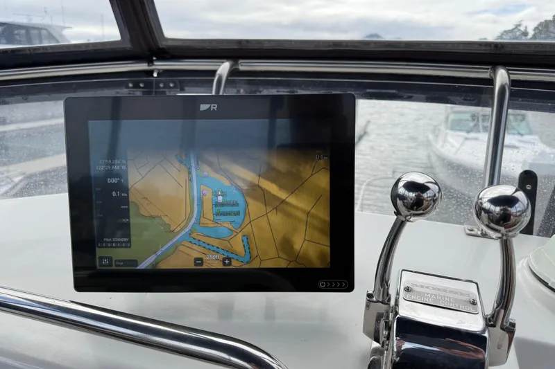 Slide: The Image of Navigation system and engine controls on a 1997 Grand Banks Classic boat. - 16