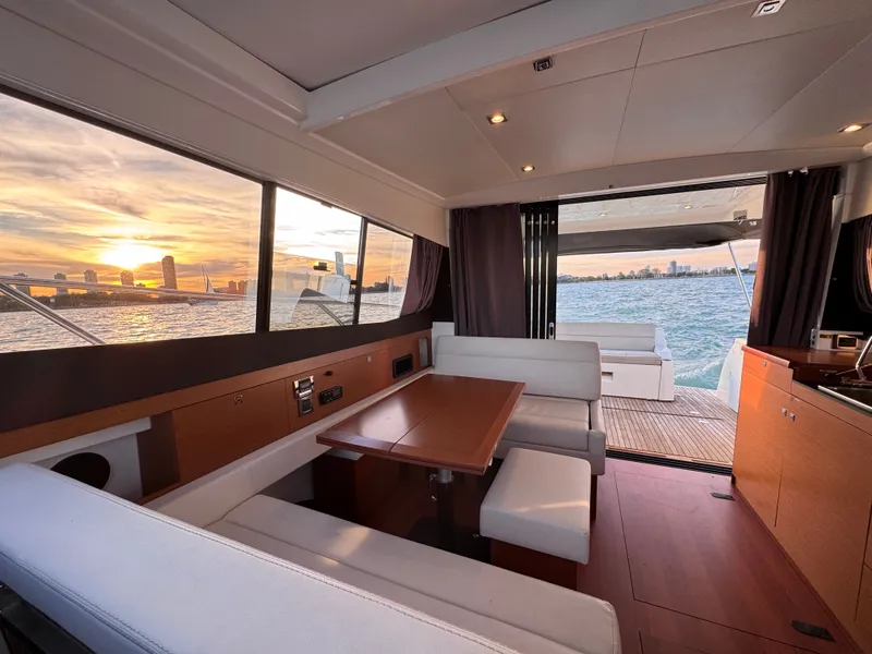 Slide: The Image of Interior of a 2017 Jeanneau NC 11 with modern design and a view of the water. - 38