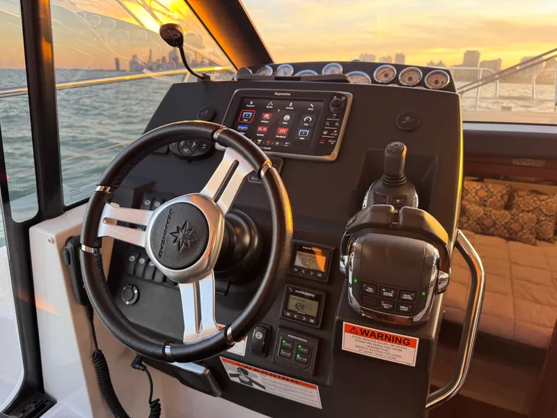 Slide: The Image of The cockpit of the 2017 Jeanneau NC 11 features a modern steering wheel and instruments. - 41