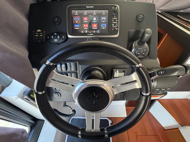 Slide: The Image of The image shows the helm of a 2017 Jeanneau NC 11 with modern instruments. - 42