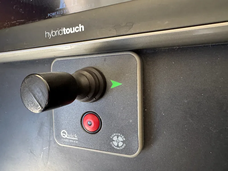 Slide: The Image of Joystick control on a boat with a red button and a green arrow. - 47