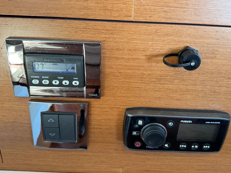 Slide: The Image of Control panel with temperature display and audio controls on wood paneling. - 48