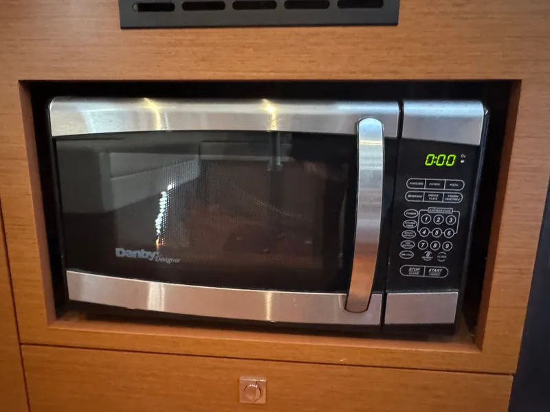Slide: The Image of A microwave oven is built into a wooden cabinet. The display shows 0:00. - 35