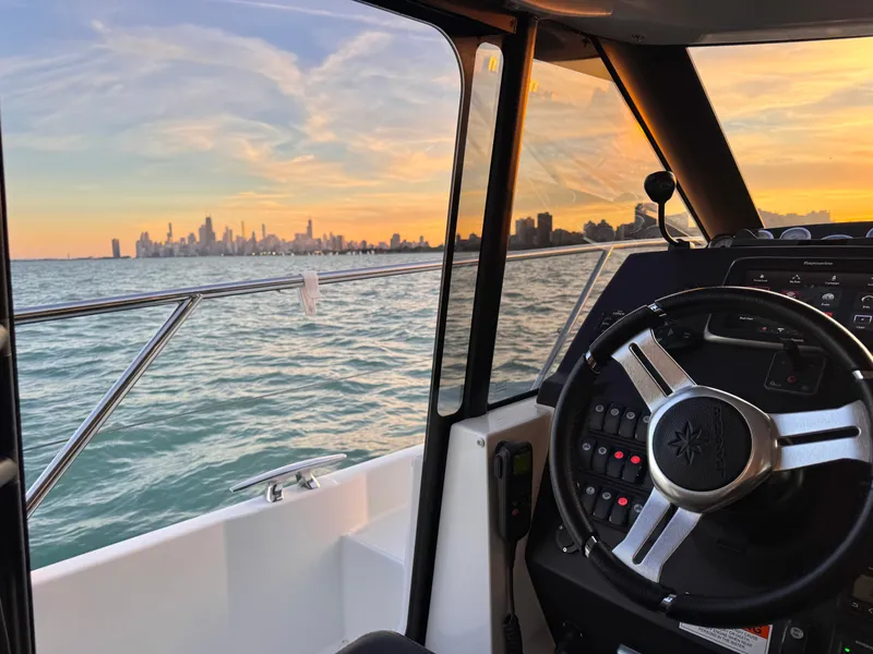 Slide: The Image of View from the cockpit of a Jeanneau NC 11, overlooking the skyline at sunset. - 37