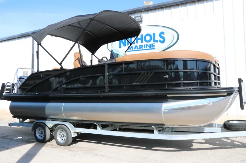 Slide: The Image of Bennington 22 MSB Tri Toon 2026 on a trailer with black canopy and brown seats. - 4