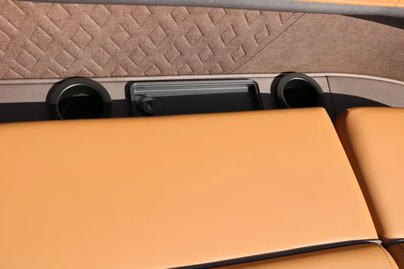 Slide: The Image of Close-up of brown upholstered seats with cup holders on a Bennington boat. - 32