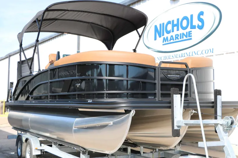 Slide: The Image of A 2026 Bennington 22 MSB Tri Toon on a trailer, featuring a black canopy. - 7