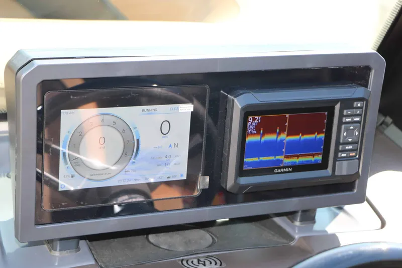Slide: The Image of The image shows the dashboard of a 2026 Bennington 22 MSB Tri Toon with a Garmin fish finder. - 47