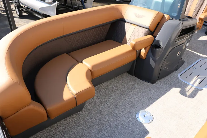 Slide: The Image of Luxurious seating area on a 2026 Bennington 22 MSB Tri Toon with brown upholstery. - 31
