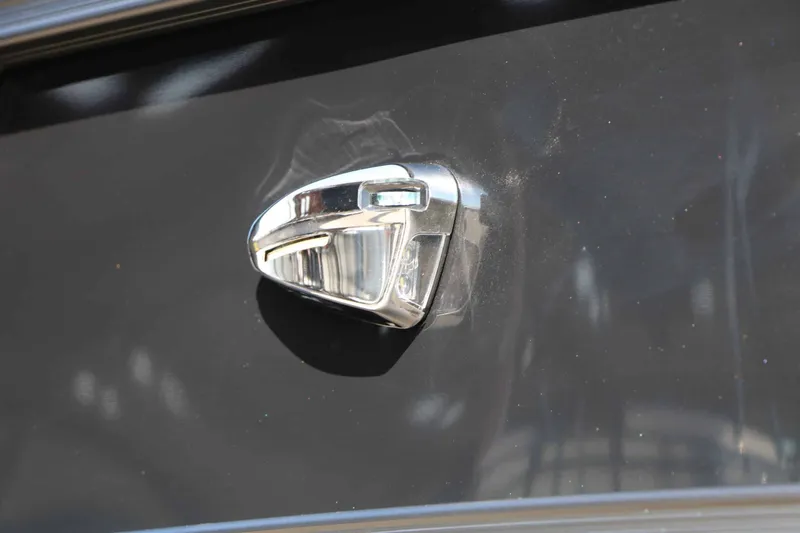Slide: The Image of Close-up of a shiny, chrome boat light on a dark surface. - 18