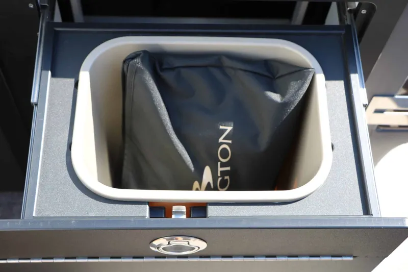 Slide: The Image of A storage compartment with a Bennington bag inside, part of a boat. - 38
