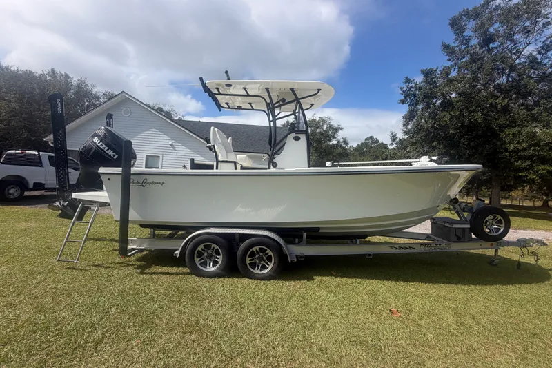 The Image of 2022 Pair Customs 21 Center Console DV boat on trailer, parked on grass. - 0