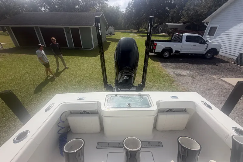 Slide: The Image of 2022 Pair Customs 21 Center Console DV boat with motor, parked near garage and truck. - 10