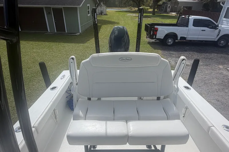 Slide: The Image of 2022 Pair Customs 21 Center Console DV boat with white seating and outdoor setting. - 8