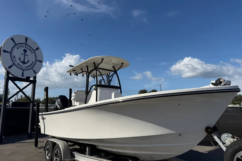 The Image of 2022 Pair Customs 21 Center Console DV boat on trailer under blue sky. - 0