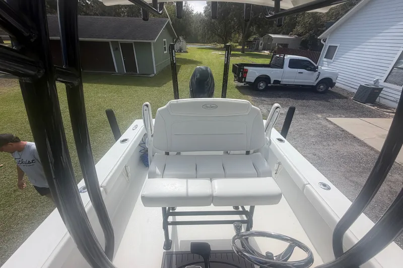 Slide: The Image of 2022 Pair Customs 21 Center Console DV boat with white seating and steering wheel. - 7