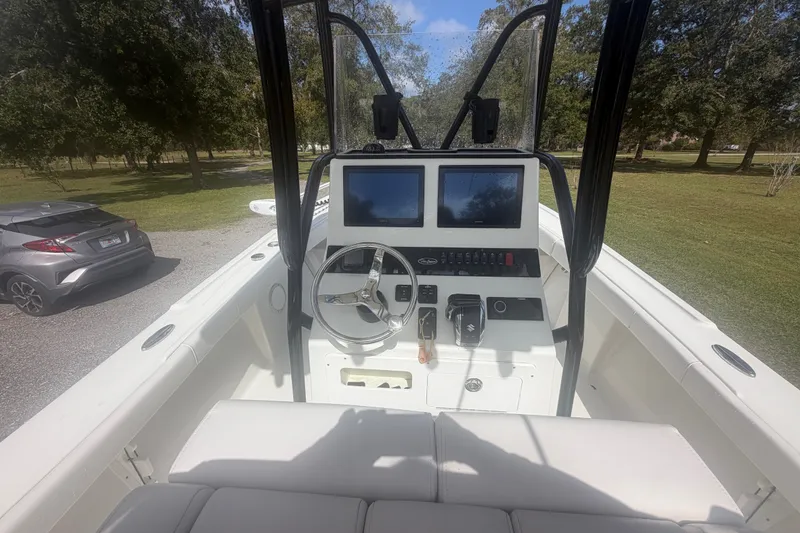 Slide: The Image of 2022 Pair Customs 21 Center Console DV boat interior with dual screens and steering wheel. - 1
