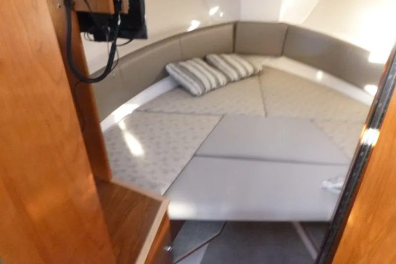 Slide: The Image of Interior cabin of 2025 Cutwater C-288 Coupe with cozy bedding and cushions. - 15