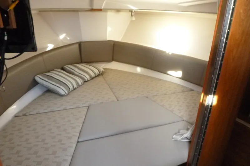 Slide: The Image of Interior cabin of 2025 Cutwater C-288 Coupe with cushioned seating and striped pillows. - 16