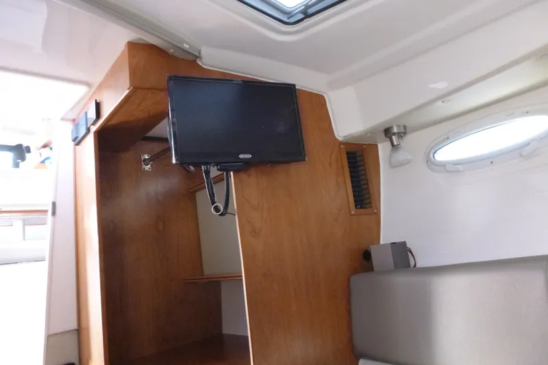 Slide: The Image of Interior of 2025 Cutwater C-288 Coupe featuring wood paneling and mounted TV. - 19