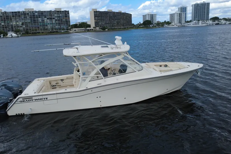 Slide: The Image of 2021 Grady-White Freedom 335 boat on water, with cityscape background. - 3