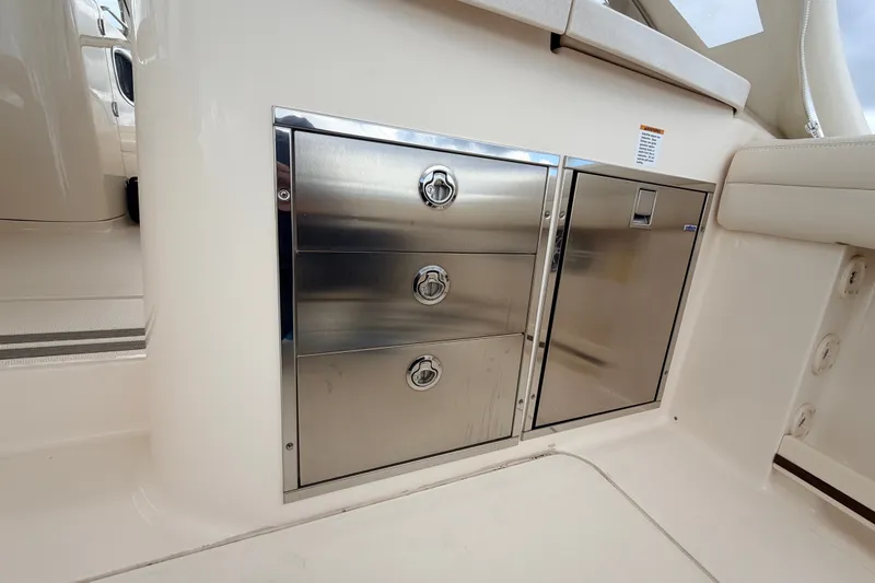 Slide: The Image of Stainless steel storage drawers on 2021 Grady-White Freedom 335 boat interior. - 32