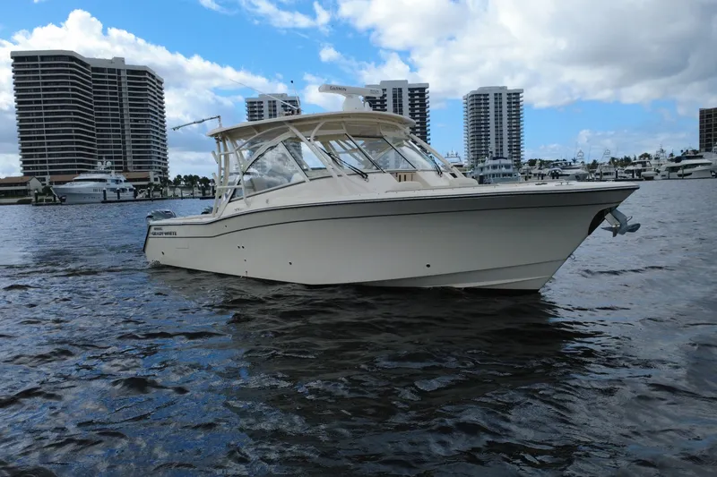 Slide: The Image of 2021 Grady-White Freedom 335 boat on water with city skyline background. - 2