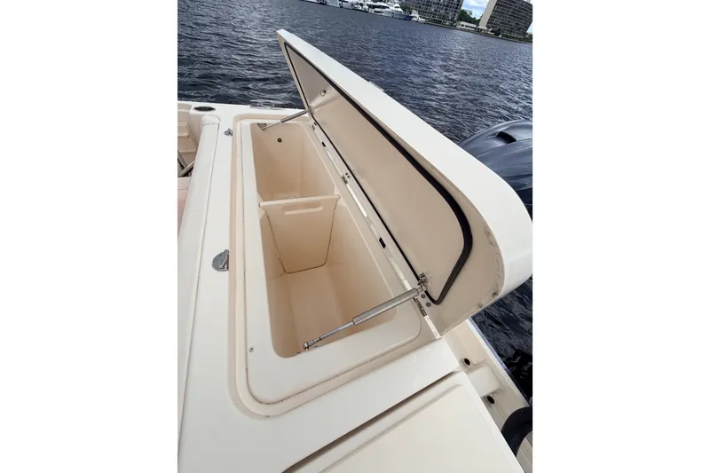Slide: The Image of Open storage compartment on 2021 Grady-White Freedom 335 boat by the water. - 42