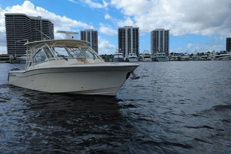 Slide: The Image of 2021 Grady-White Freedom 335 boat on water with city skyline background. - 1