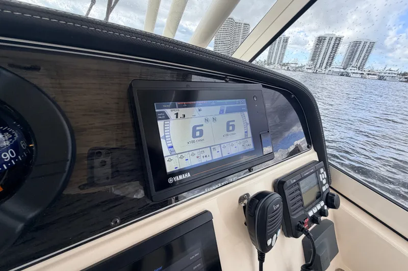 Slide: The Image of Dashboard of 2021 Grady-White Freedom 335 boat with Yamaha display and controls. - 16