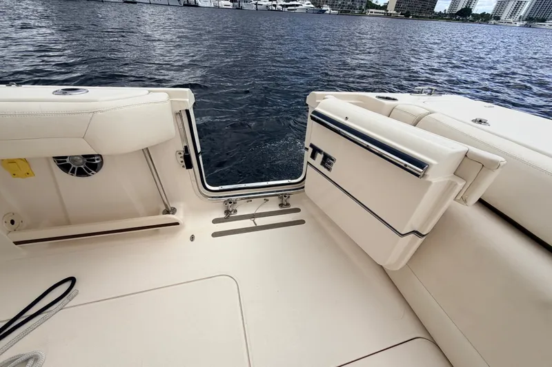 Slide: The Image of 2021 Grady-White Freedom 335 boat interior with open transom door, dockside view. - 38