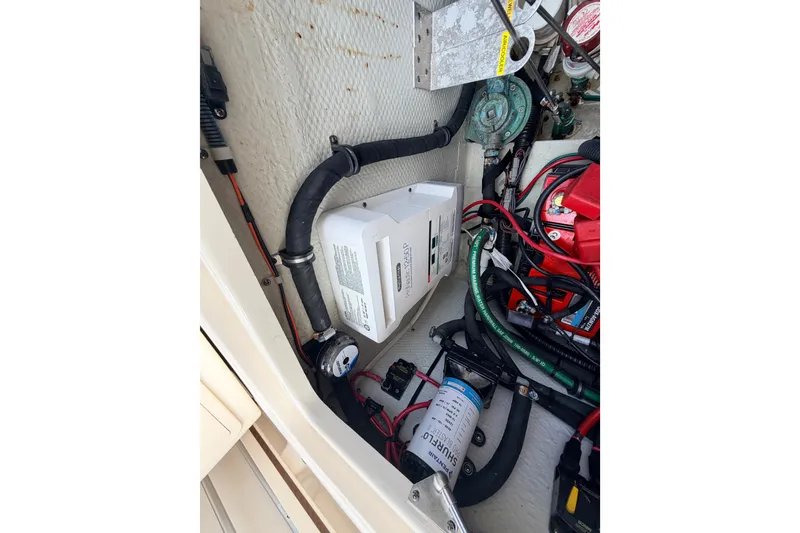 Slide: The Image of 2021 Grady-White Freedom 335 boat engine compartment with wiring and components. - 61