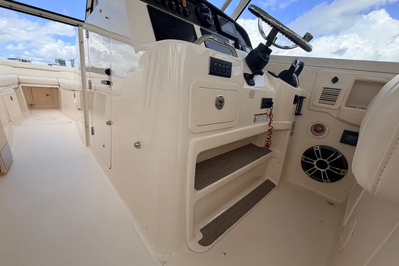 Slide: The Image of 2021 Grady-White Freedom 335 boat interior with helm and seating area. - 52