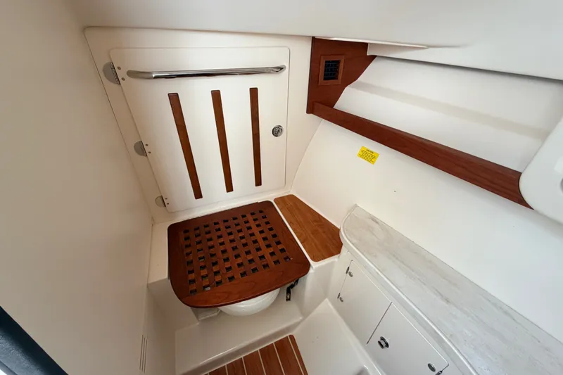 Slide: The Image of 2021 Grady-White Freedom 335 boat interior with wooden accents and storage compartments. - 23