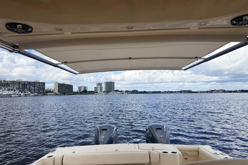 Slide: The Image of 2021 Grady-White Freedom 335 boat on water, city skyline in background. - 48