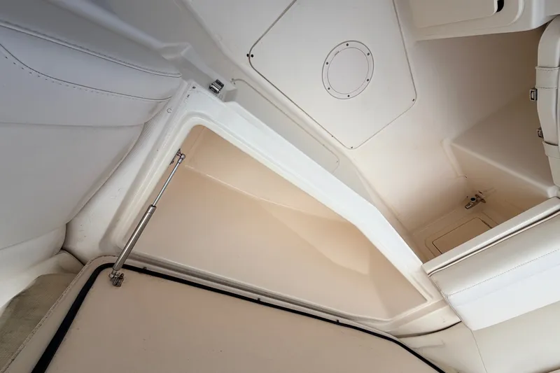 Slide: The Image of Interior storage compartment of 2021 Grady-White Freedom 335 boat, featuring white upholstery. - 55