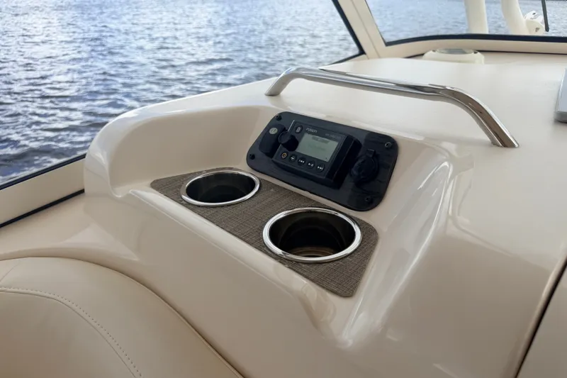 Slide: The Image of 2021 Grady-White Freedom 335 boat console with cup holders and control panel. - 45