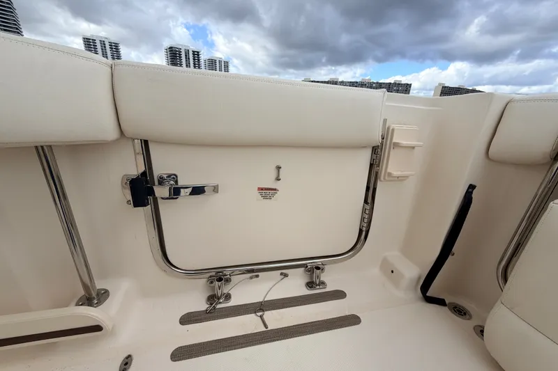 Slide: The Image of 2021 Grady-White Freedom 335 boat interior with cushioned seating and stainless steel fittings. - 37