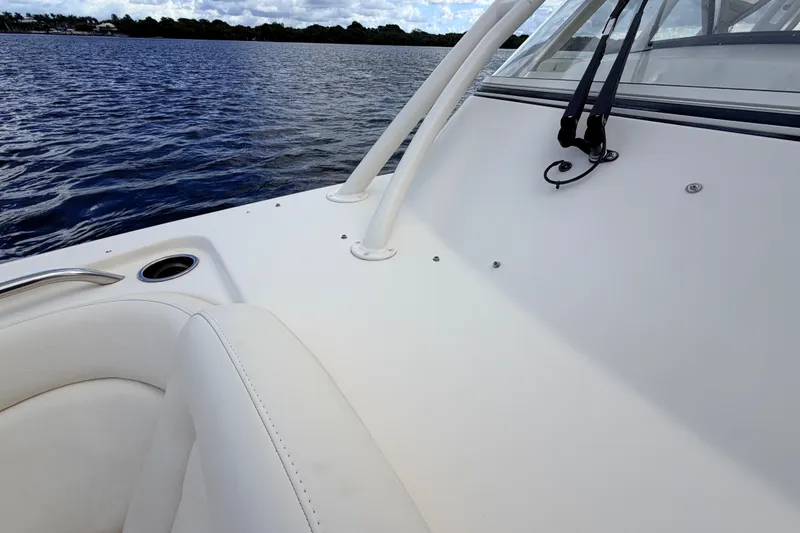 Slide: The Image of 2021 Grady-White Freedom 335 boat interior with white seating, near calm water. - 11