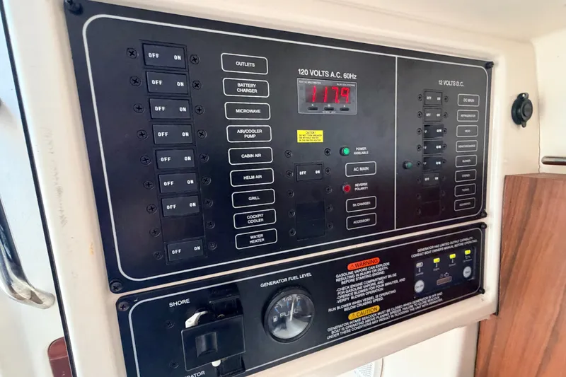 Slide: The Image of Control panel of a 2021 Grady-White Freedom 335 boat, showing switches and voltage display. - 53