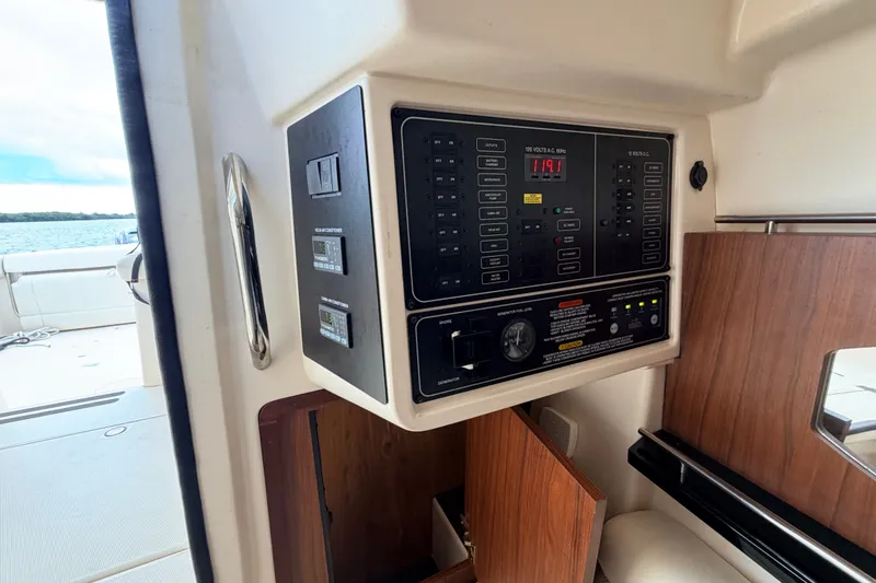 Slide: The Image of Control panel inside 2021 Grady-White Freedom 335 boat, with view of the deck and water. - 50