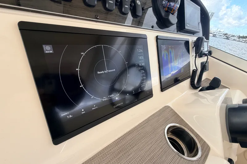 Slide: The Image of Dashboard of 2021 Grady-White Freedom 335 boat with navigation screens and controls. - 17